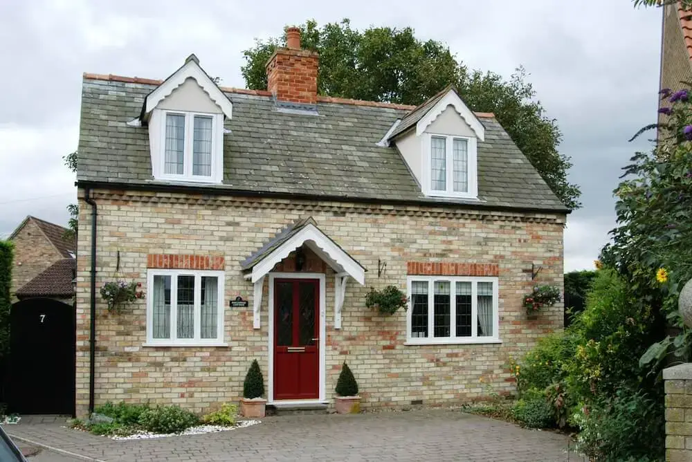 House with white Logik uPVC windows and red entrance door